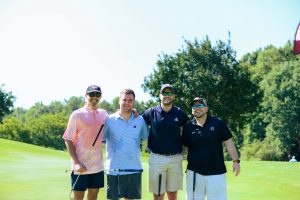 Four Golfers Smiling and Having Fun